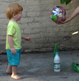 Toddler steps forward to take ball 1.jpg